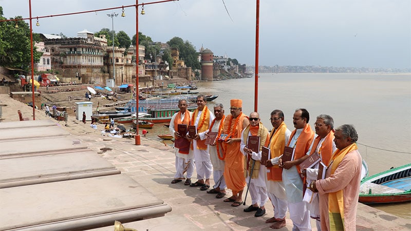 A group of distinguished scholars venerate the text at the holy banks of Ganga in Varanasi